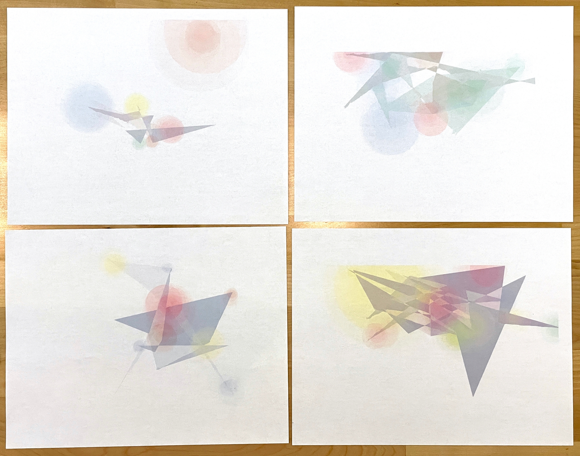 Four printed graphs of varying complexity -- overlaying geometric shapes and colors