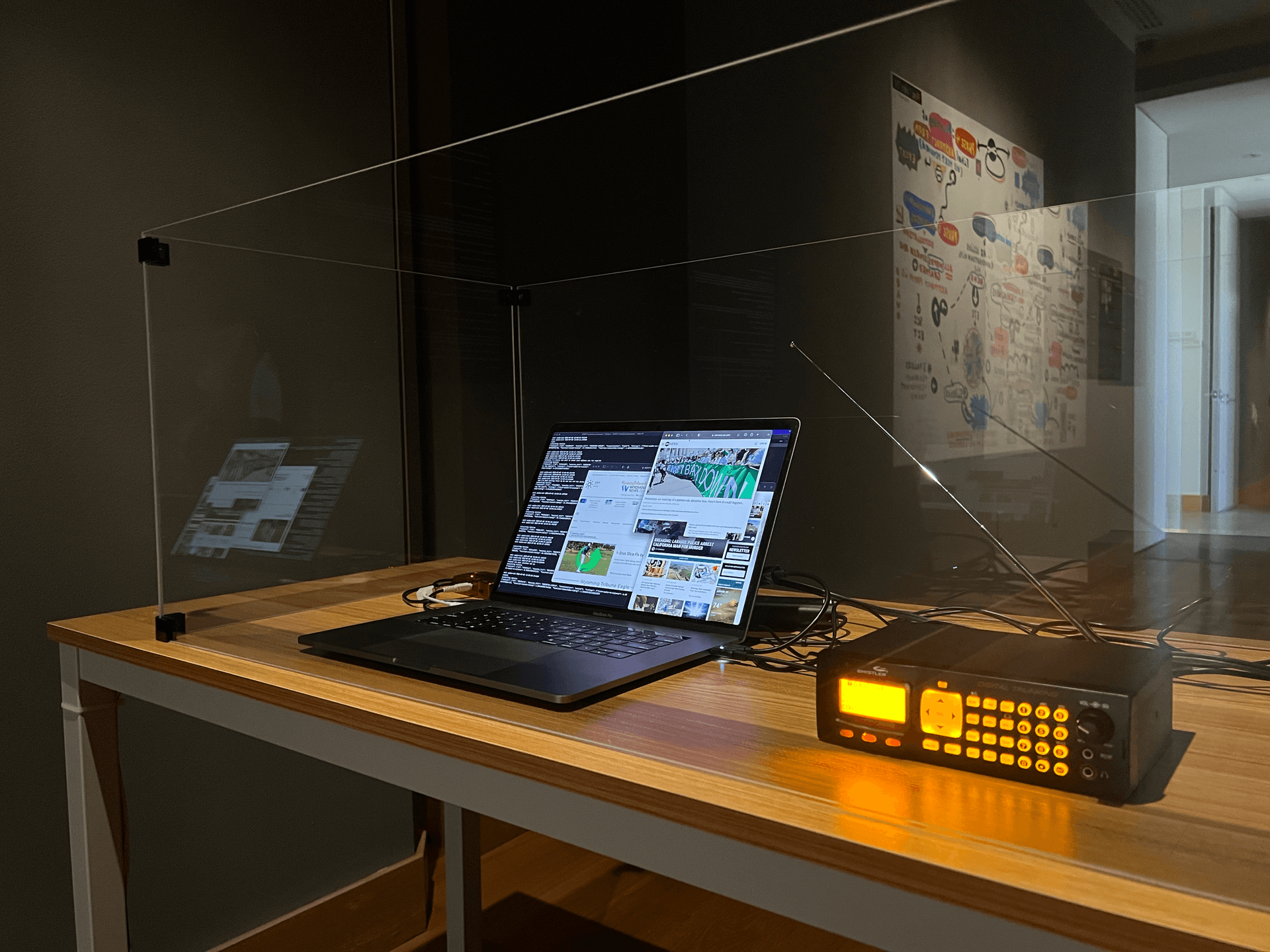 A closeup of the police scanner table showing the scanner and a laptop running software that transcribes the scanner feed